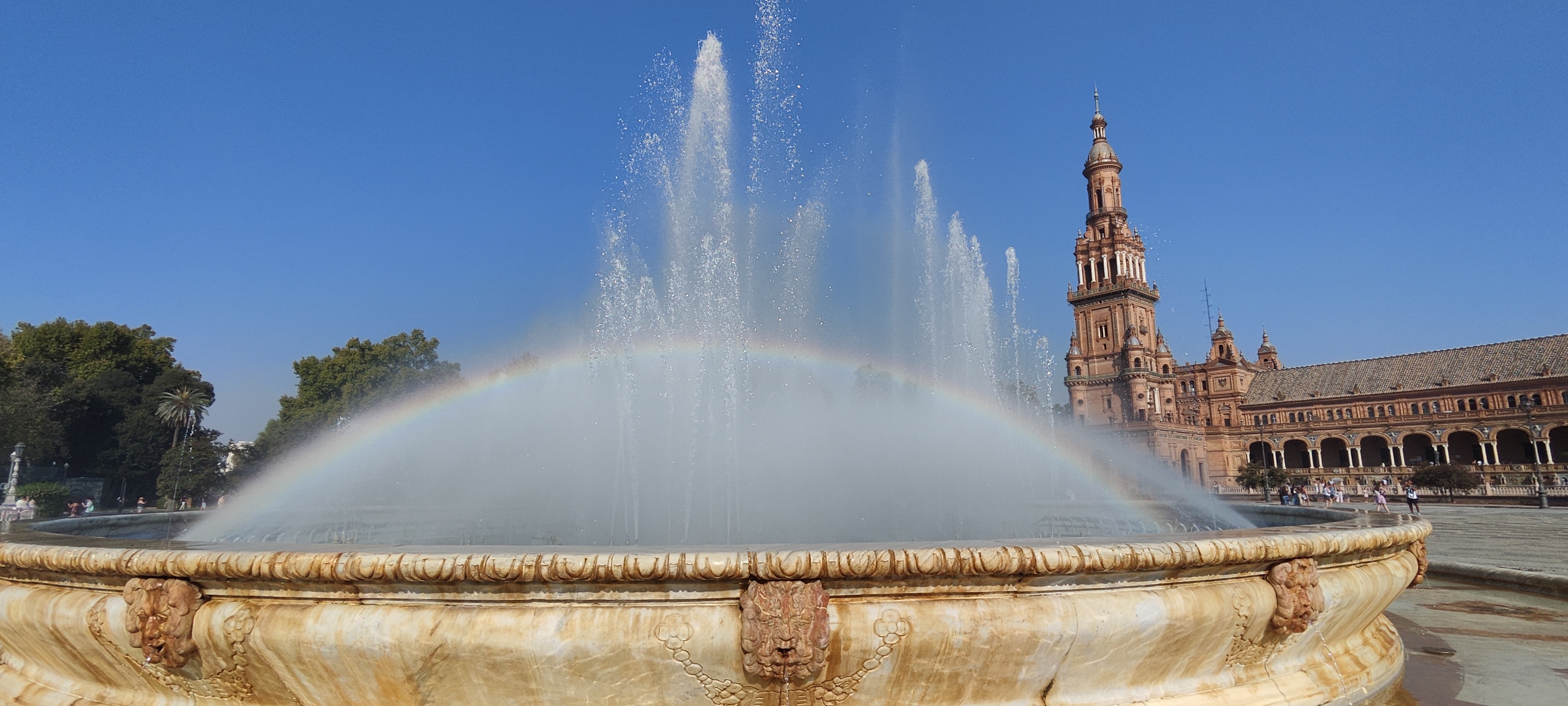 Morning view of Plaza de España in Seville with reflections in the water