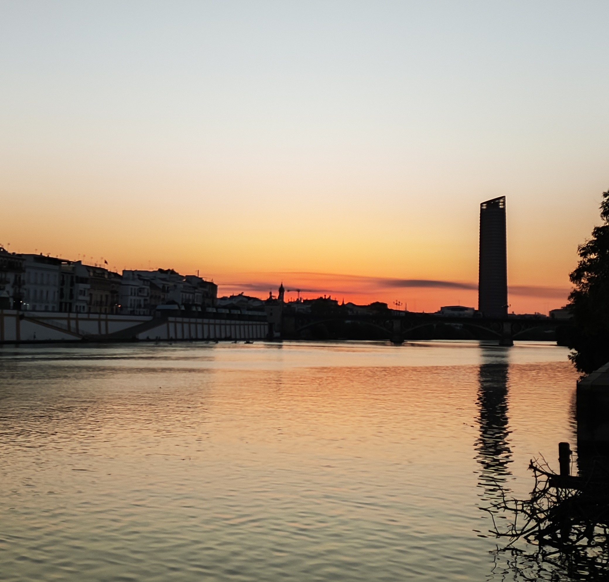 Sunset view over the Guadalquivir river towards Triana neighborhood in Seville